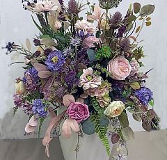 Композиция из искусственных цветов в светлой напольной вазе