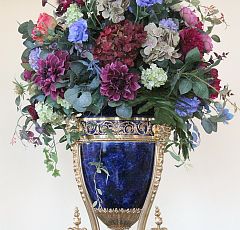 Композиция из искусственных цветов в сине-золотой винтажной вазе